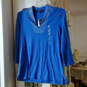 A blue light long sleeve with rhinestones around the collar